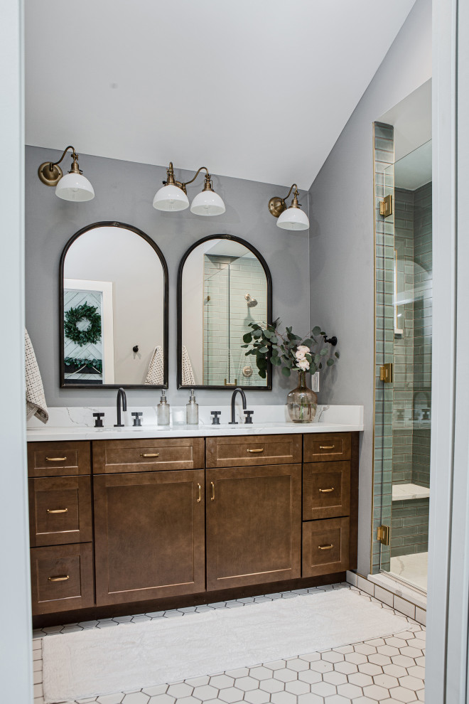 Mid-sized traditional master bathroom in Denver with shaker cabinets, medium wood cabinets, an alcove shower, a two-piece toilet, blue tile, ceramic tile, grey walls, ceramic floors, an undermount sink, engineered quartz benchtops, beige floor, a hinged shower door, white benchtops, a shower seat, a double vanity, a built-in vanity and vaulted.