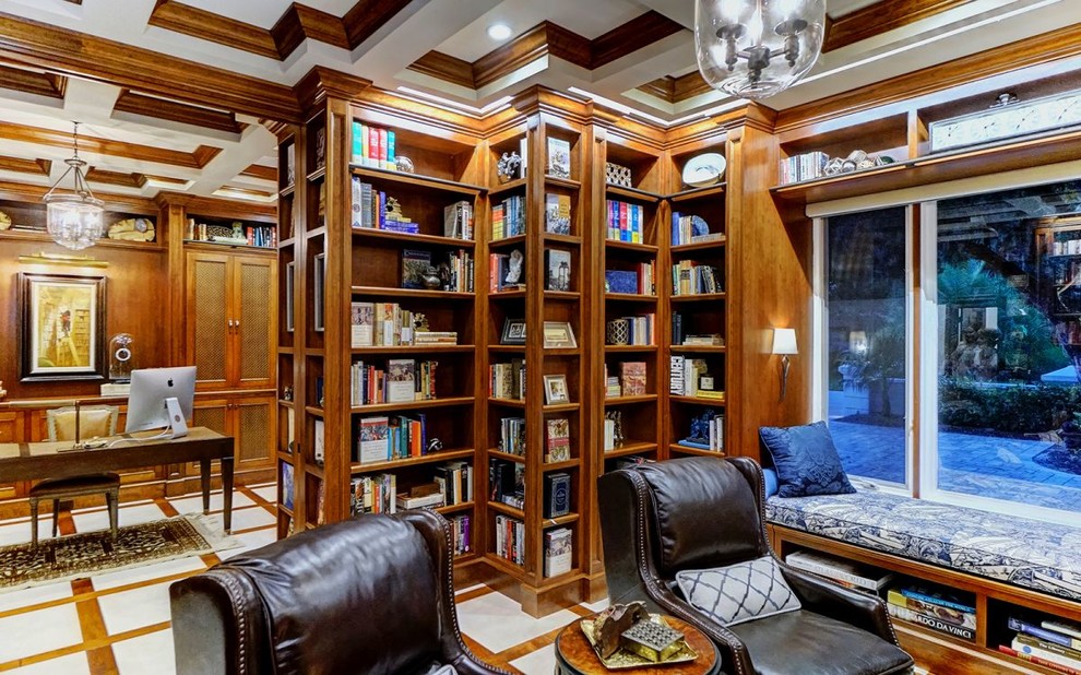 Large eclectic home office in Tampa with a library, brown walls, carpet, no fireplace, a freestanding desk and beige floor.