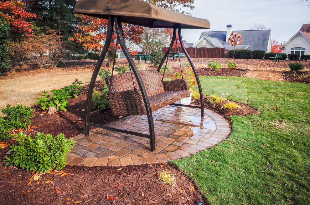 This is an example of a small arts and crafts backyard patio in Other with brick pavers and no cover.