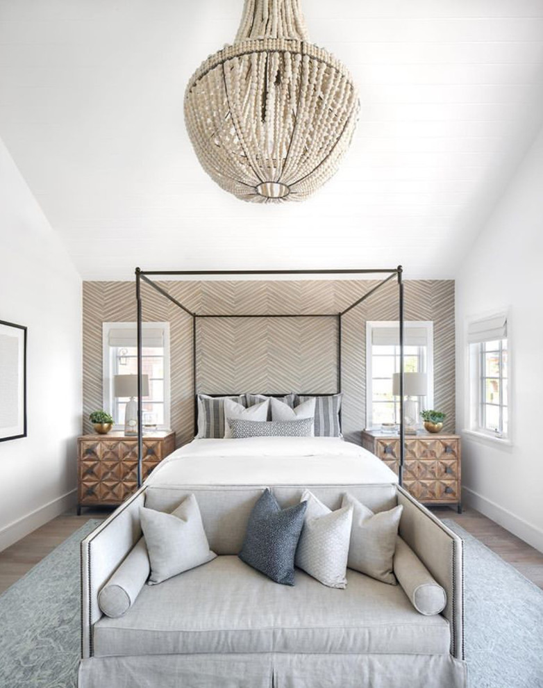 Example of a transitional medium tone wood floor and brown floor bedroom design in Orange County with white walls