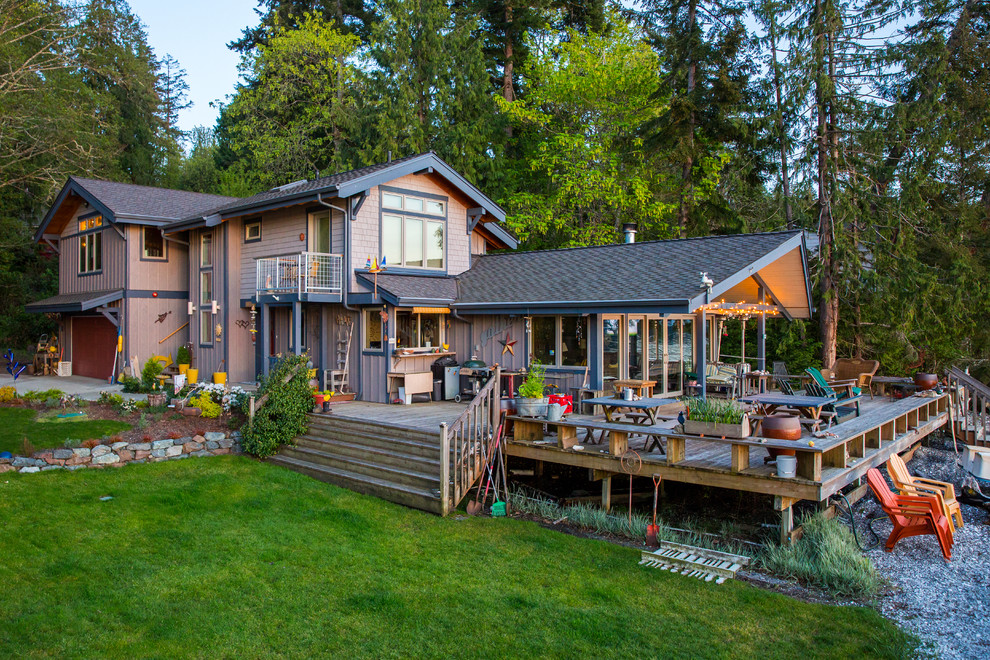 Large transitional brown two-story mixed siding gable roof idea with a shingle roof