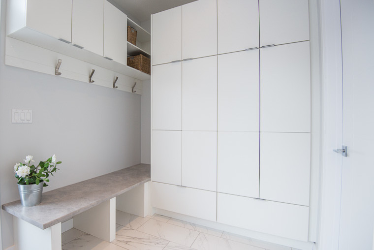 Photo of a mid-sized contemporary mudroom in Other with grey walls, marble floors and white floor.