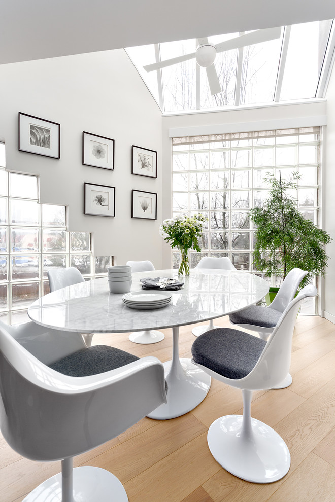 Kitchen/dining room combo - mid-sized contemporary light wood floor and beige floor kitchen/dining room combo idea in Vancouver with white walls and no fireplace