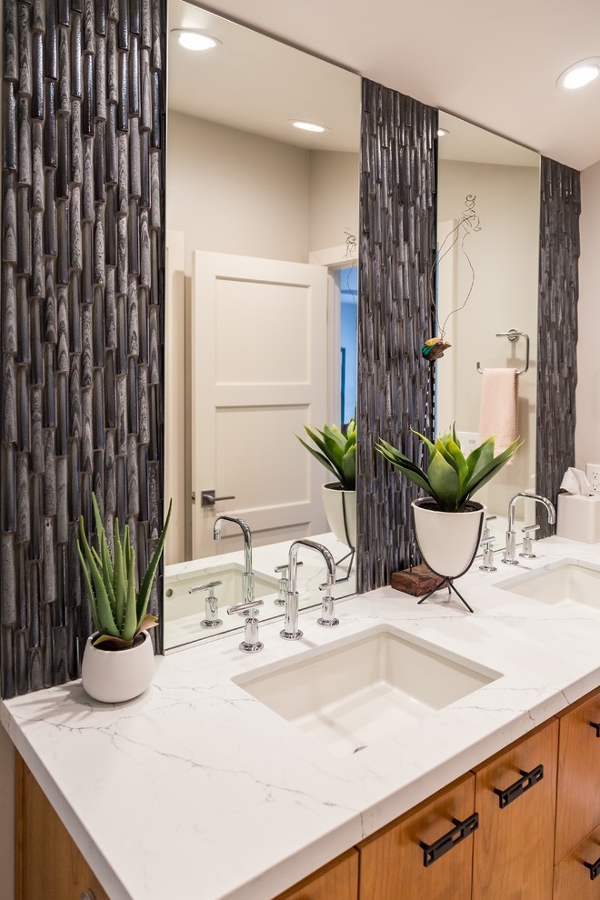 Large midcentury master bathroom in San Diego with shaker cabinets, medium wood cabinets, a curbless shower, a two-piece toilet, brown tile, glass sheet wall, white walls, ceramic floors, an undermount sink, granite benchtops, white floor, a hinged shower door and white benchtops.