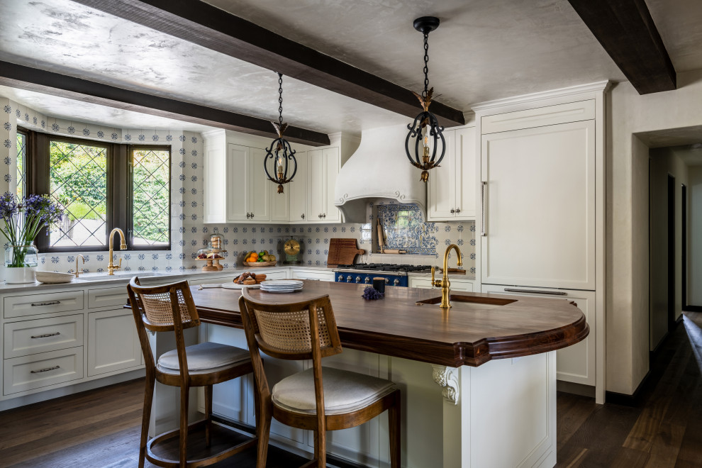 Inspiration for a large transitional l-shaped dark wood floor, brown floor and exposed beam eat-in kitchen remodel in Seattle with recessed-panel cabinets, white cabinets, porcelain backsplash, an island, white countertops, marble countertops, multicolored backsplash and colored appliances