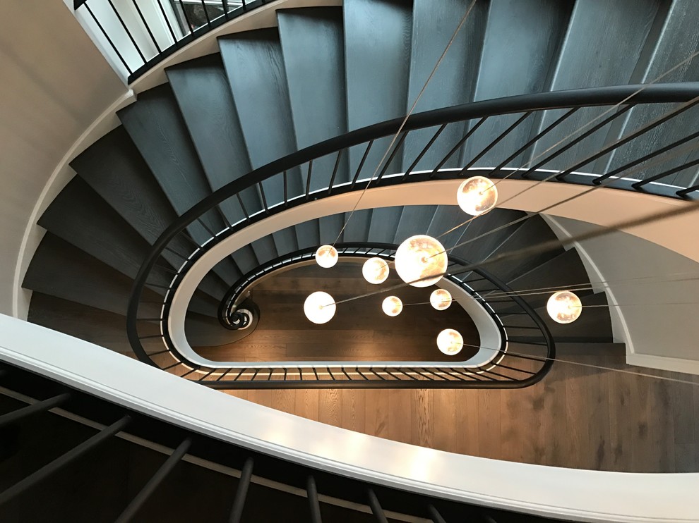 Design ideas for an expansive contemporary painted wood spiral staircase in Chicago with painted wood risers and metal railing.