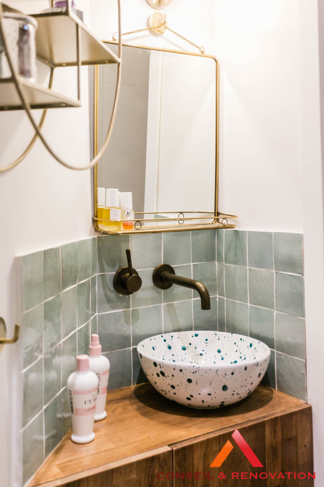 Small contemporary bathroom in Paris with beaded inset cabinets, dark wood cabinets, an alcove shower, green tile, terra-cotta tile, green walls, wood-look tile, a drop-in sink, wood benchtops, brown floor, a hinged shower door, blue benchtops, a single vanity and a built-in vanity.
