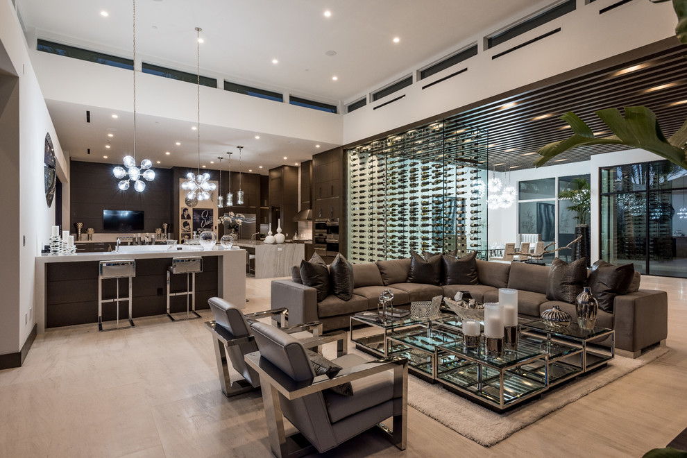 Large contemporary open concept family room in Las Vegas with white walls, light hardwood floors, a ribbon fireplace, a wall-mounted tv, a stone fireplace surround, beige floor and a home bar.