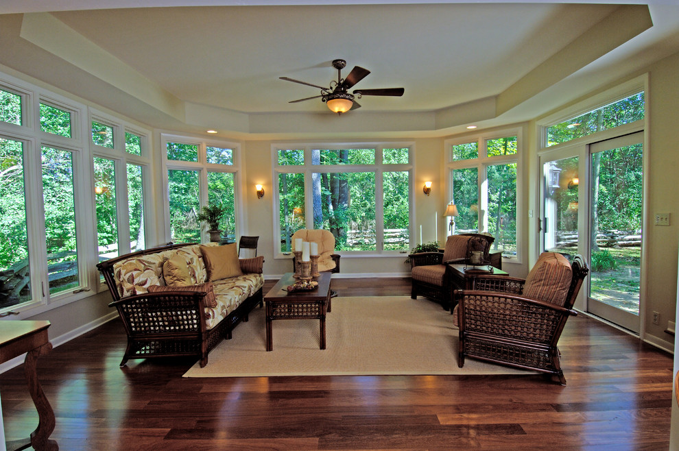 This is an example of a large tropical formal open concept living room in Milwaukee with beige walls, dark hardwood floors, no fireplace, no tv and brown floor.
