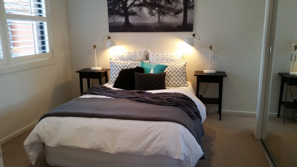 Photo of a small contemporary master bedroom in Melbourne with white walls and carpet.