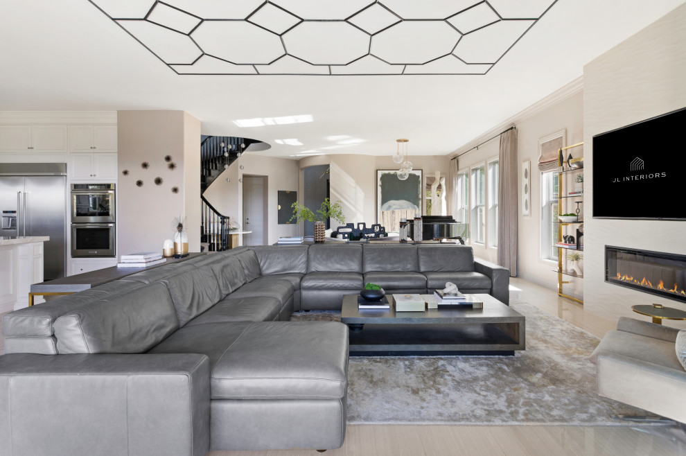 Expansive contemporary formal open concept living room in Los Angeles with beige walls, porcelain floors, a hanging fireplace, a tile fireplace surround, a wall-mounted tv, beige floor and wood.