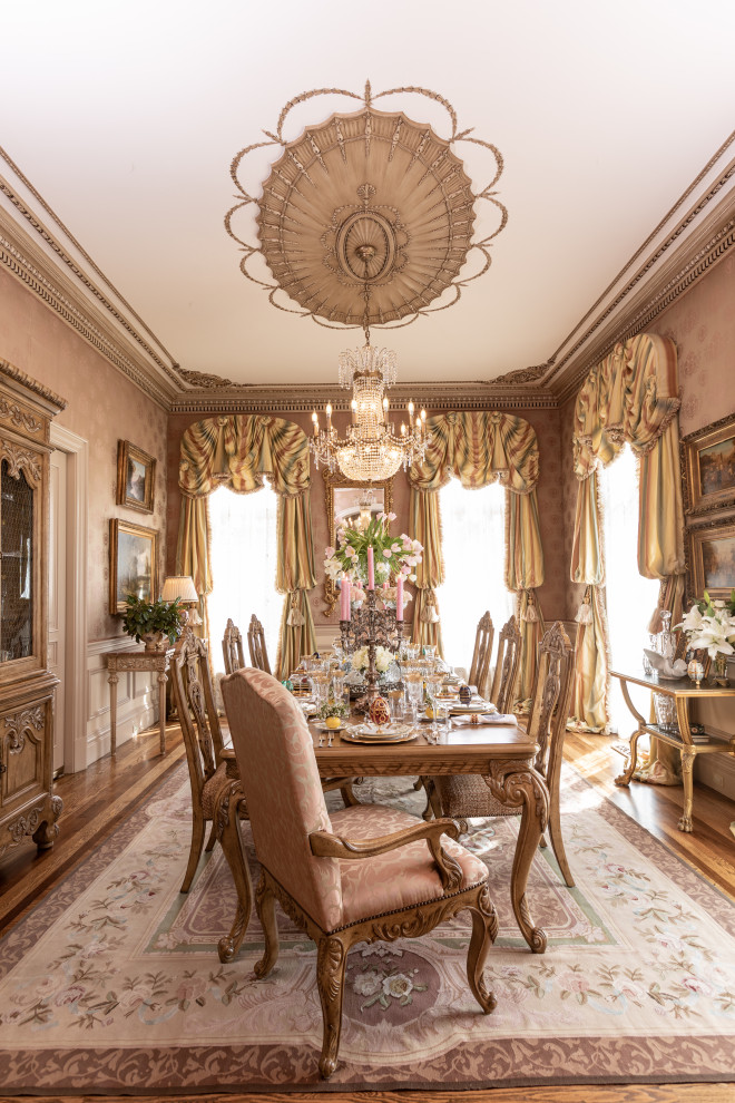 This is an example of a separate dining room in Other with light hardwood floors and wallpaper.