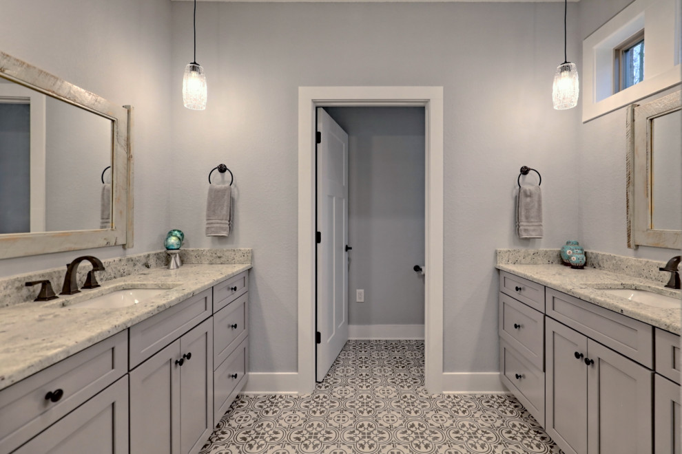Inspiration for a large traditional ensuite bathroom in Atlanta with shaker cabinets, grey cabinets, an alcove shower, a two-piece toilet, grey walls, a submerged sink, granite worktops, grey floors, a hinged door, white worktops, an enclosed toilet, double sinks, a built in vanity unit and ceramic flooring.