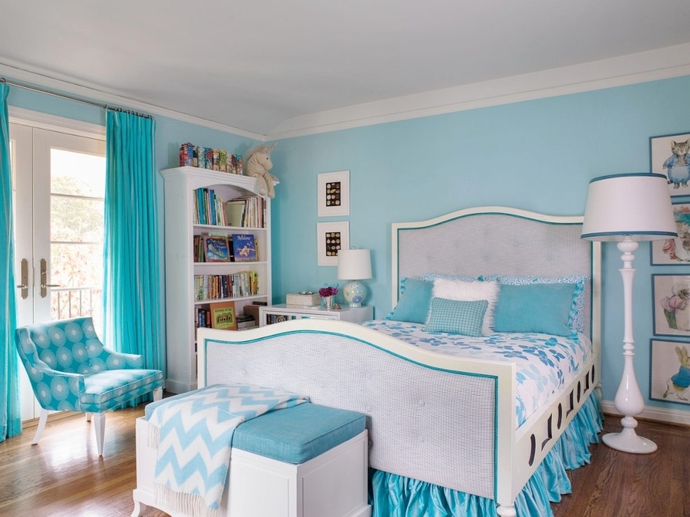 Mid-sized transitional kids' bedroom in San Francisco with blue walls, medium hardwood floors and brown floor for kids 4-10 years old and girls.