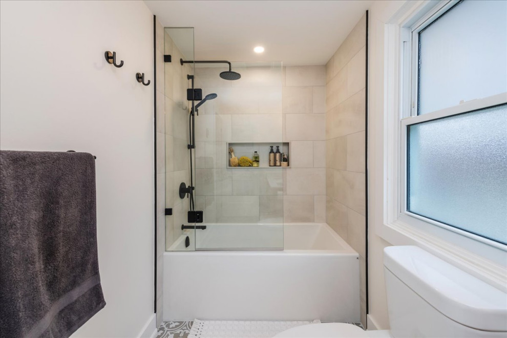Mid-sized transitional master bathroom in Toronto with shaker cabinets, light wood cabinets, a drop-in tub, a shower/bathtub combo, a one-piece toilet, beige tile, porcelain tile, white walls, porcelain floors, an undermount sink, engineered quartz benchtops, beige floor, a hinged shower door, white benchtops, a double vanity and a built-in vanity.