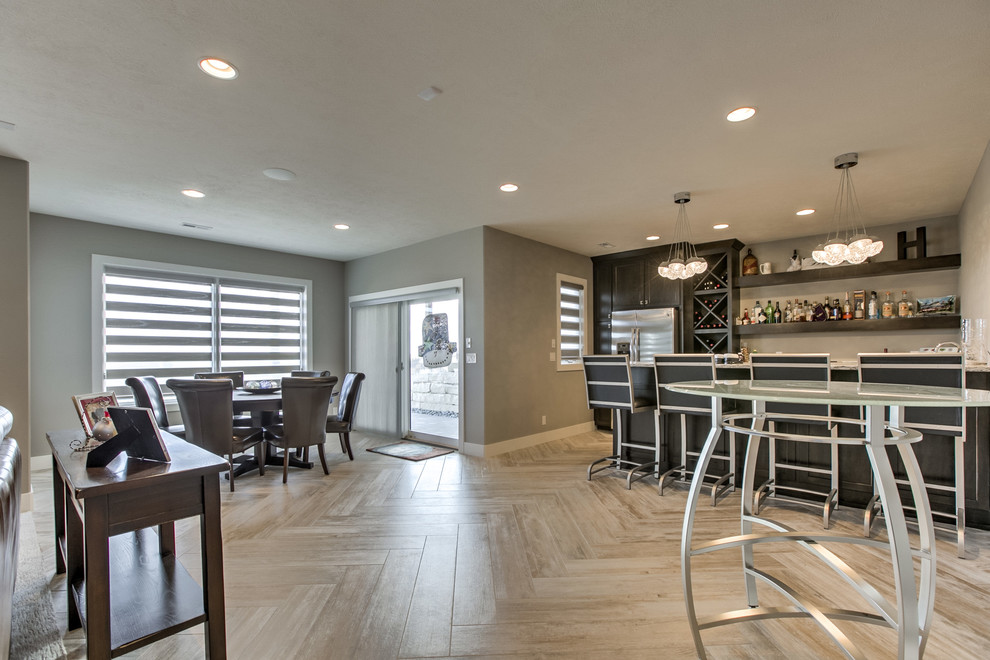 Basement - transitional walk-out carpeted basement idea in Omaha with a stone fireplace