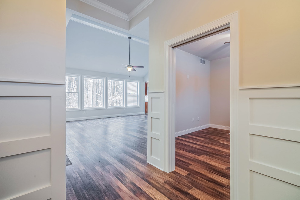 Large transitional front door in New York with beige walls, medium hardwood floors, a single front door, a dark wood front door and multi-coloured floor.
