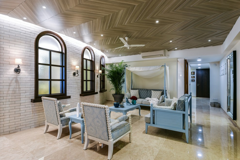 Inspiration for a mid-sized beach style open concept family room in Mumbai with white walls and beige floor.