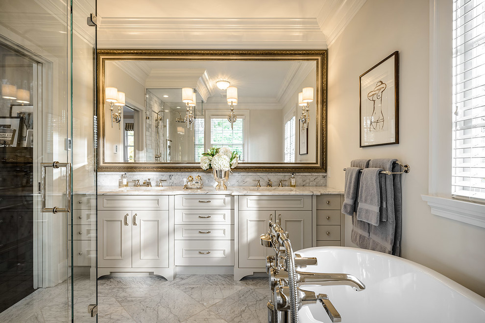 Design ideas for a traditional bathroom in Vancouver with recessed-panel cabinets, grey cabinets, marble benchtops, a freestanding tub, gray tile, grey walls, marble floors and a curbless shower.