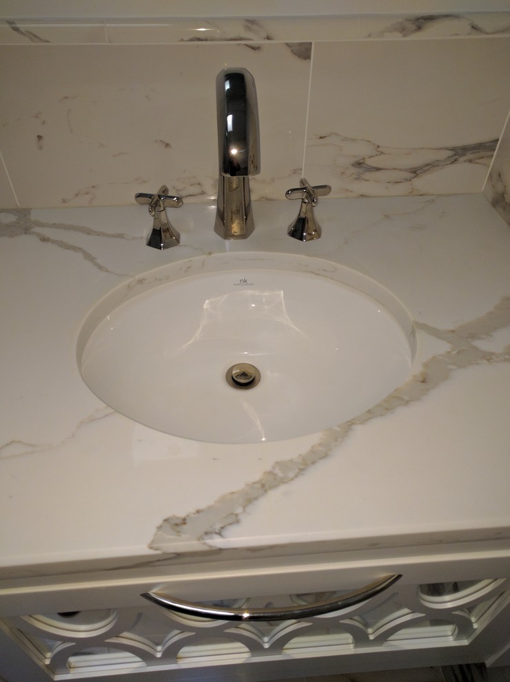 Inspiration for a mid-sized transitional master gray tile marble floor alcove bathtub remodel in DC Metro with furniture-like cabinets, white cabinets, a wall-mount toilet, gray walls, an undermount sink and marble countertops