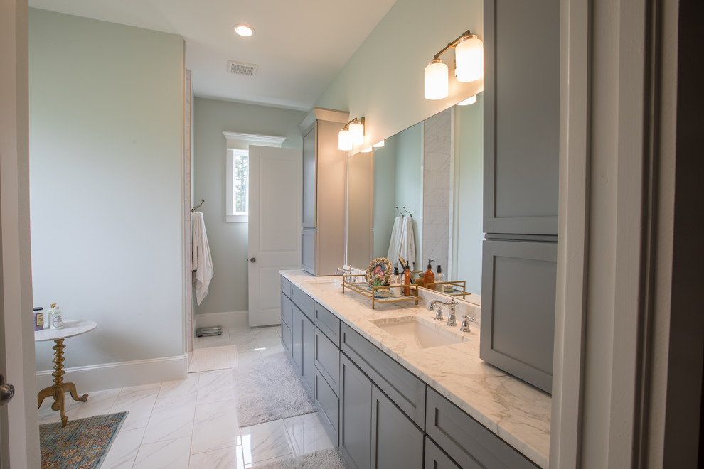 Mid-sized traditional master bathroom in Houston with shaker cabinets, grey cabinets, a freestanding tub, grey walls, an undermount sink, marble benchtops, white floor and white benchtops.