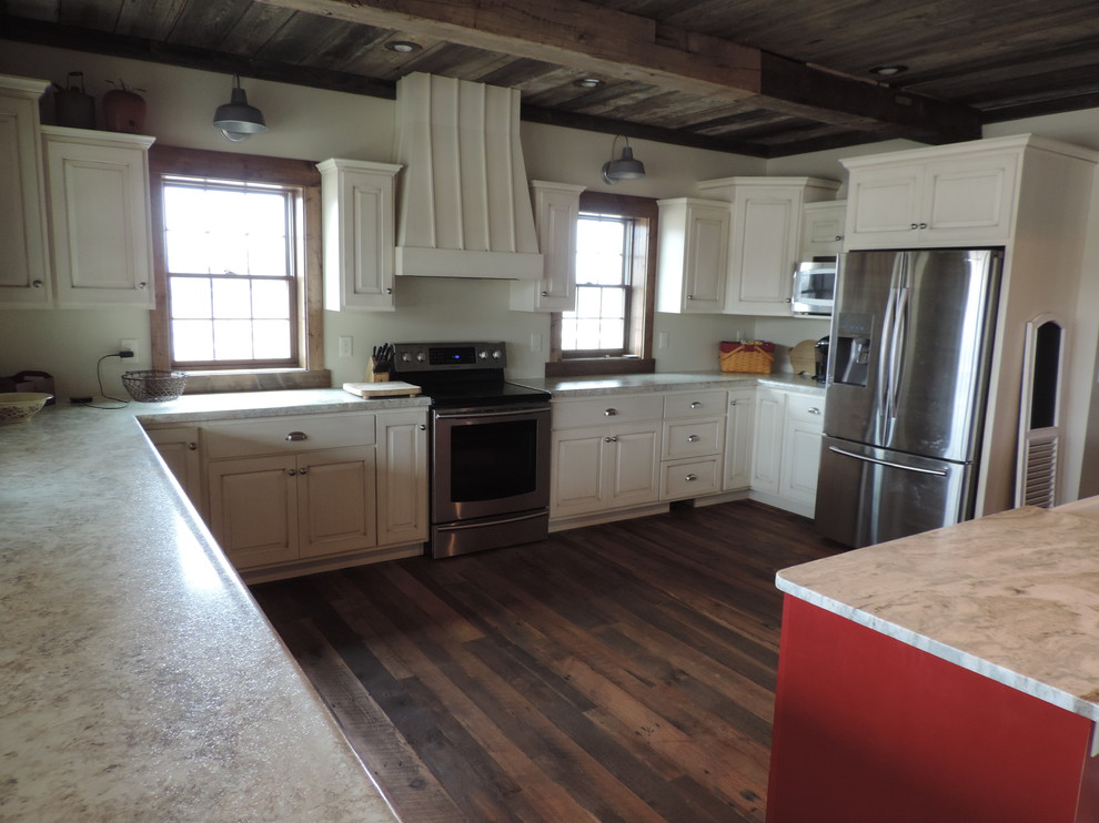 Example of a large mountain style u-shaped dark wood floor eat-in kitchen design with raised-panel cabinets, white cabinets, gray backsplash, marble backsplash, stainless steel appliances and an island
