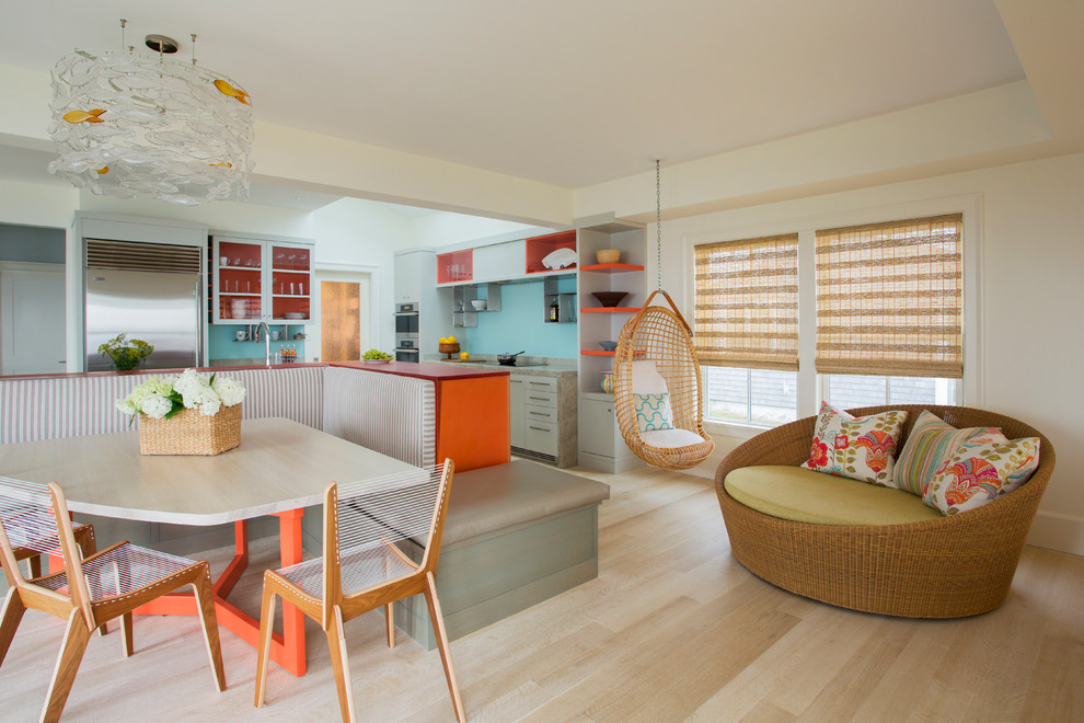 This is an example of a beach style kitchen/dining combo in Providence with white walls and light hardwood floors.