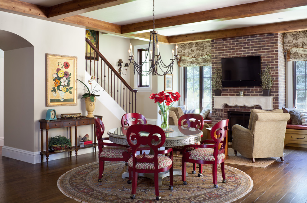 This is an example of a traditional open plan dining in Denver with beige walls and dark hardwood floors.