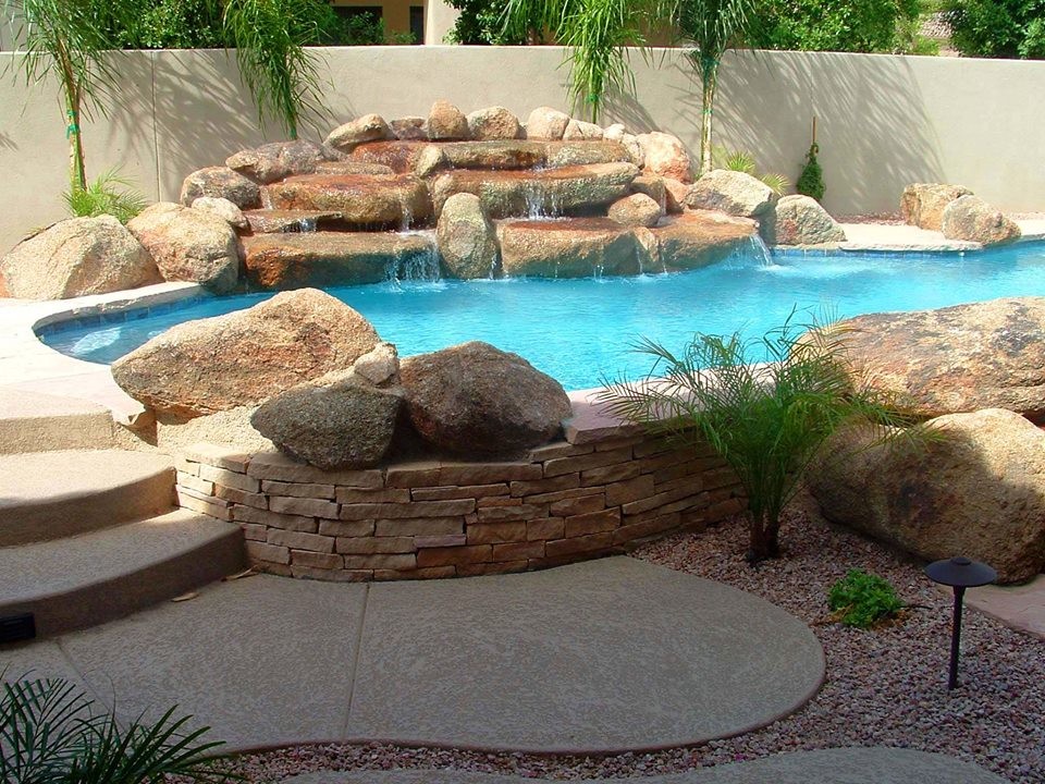 Example of a mid-sized transitional backyard stone and custom-shaped natural pool design in Phoenix