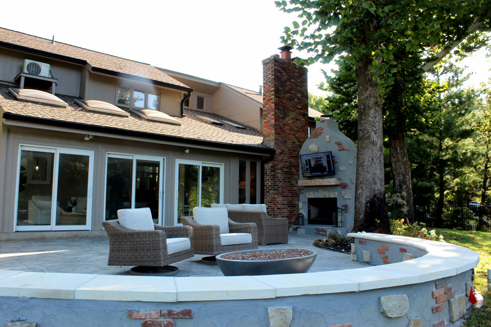 Inspiration for a large transitional full sun backyard brick landscaping in Kansas City with a fireplace.