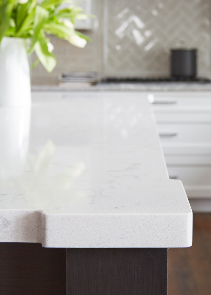Large transitional u-shaped medium tone wood floor open concept kitchen photo in Chicago with a double-bowl sink, flat-panel cabinets, white cabinets, quartz countertops, beige backsplash, subway tile backsplash, stainless steel appliances and an island