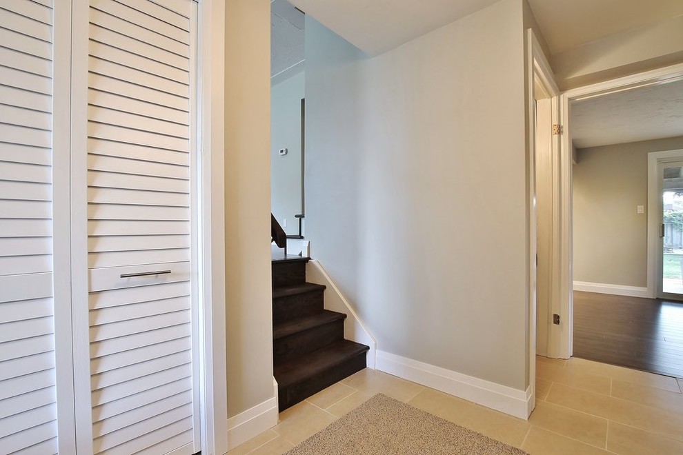 Inspiration for a small travertine floor foyer remodel with gray walls and a white front door