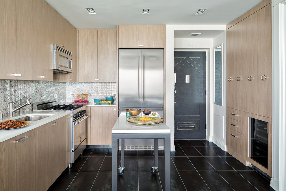 This is an example of a mid-sized contemporary u-shaped kitchen in New York with an undermount sink, flat-panel cabinets, light wood cabinets, quartz benchtops, metallic splashback, mosaic tile splashback, stainless steel appliances, porcelain floors, with island and black floor.