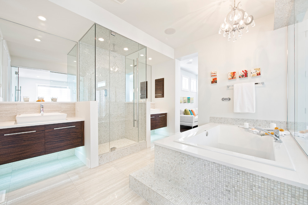 This is an example of a contemporary bathroom in Calgary with a vessel sink, flat-panel cabinets, dark wood cabinets, a drop-in tub, an alcove shower, white tile and mosaic tile.