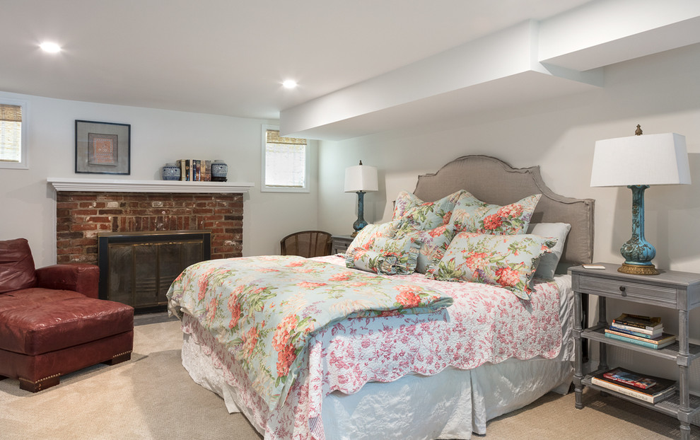 Design ideas for a mid-sized transitional guest bedroom in DC Metro with white walls, carpet, a standard fireplace, a brick fireplace surround and beige floor.