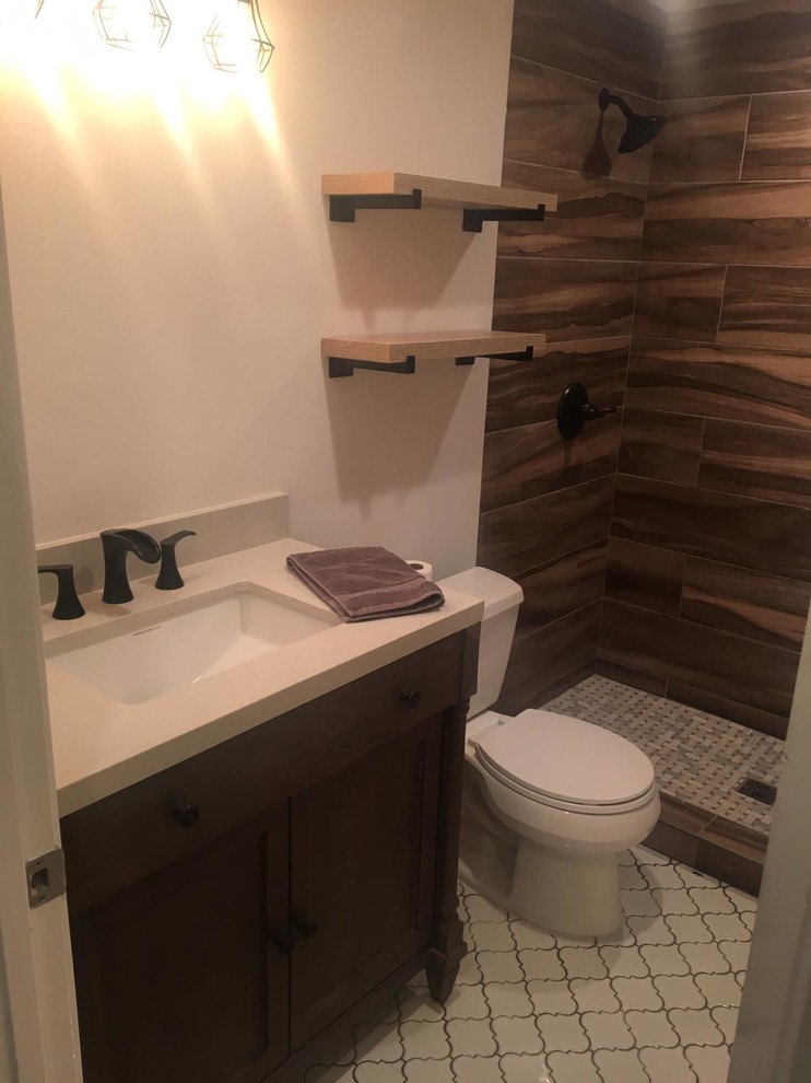 Inspiration for a small country 3/4 bathroom in Los Angeles with shaker cabinets, dark wood cabinets, an alcove shower, a two-piece toilet, brown tile, porcelain tile, white walls, cement tiles, an undermount sink, engineered quartz benchtops, white floor, an open shower and white benchtops.