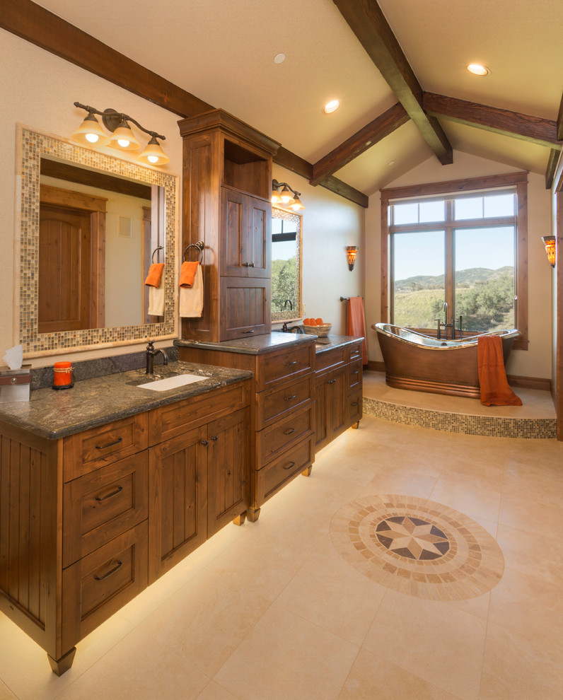 Freestanding bathtub - large rustic master beige floor freestanding bathtub idea with an undermount sink, recessed-panel cabinets, granite countertops, beige walls and medium tone wood cabinets