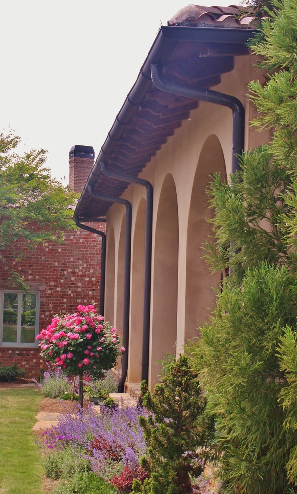 This is an example of a large mediterranean two-storey stucco beige exterior in Atlanta.