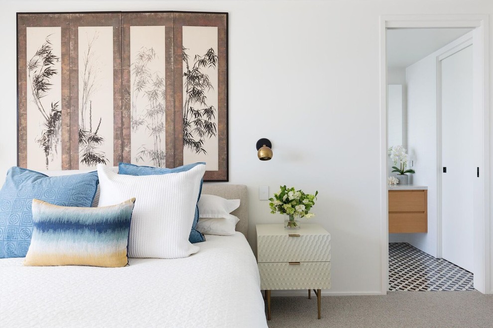 This is an example of a contemporary master bedroom in Sydney with white walls, carpet and grey floor.