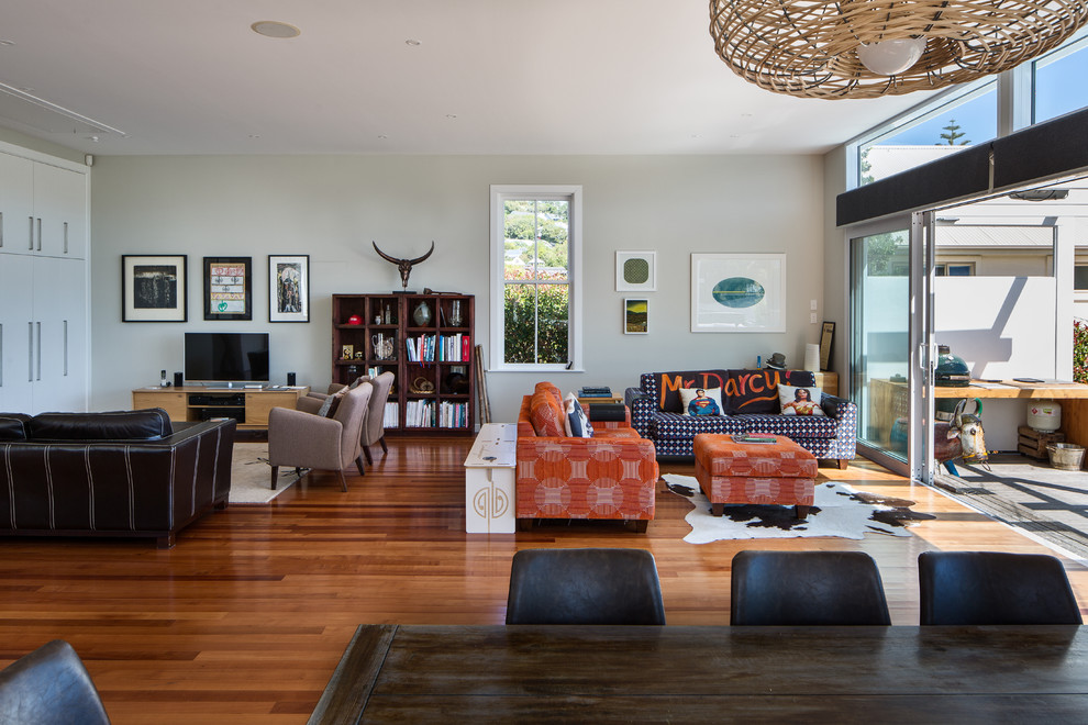 Inspiration for an expansive contemporary open concept living room in Wellington with brown floor and medium hardwood floors.