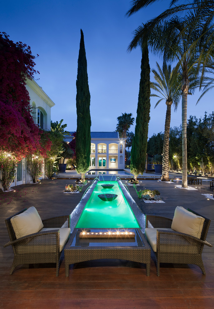 Inspiration for a mediterranean backyard deck in Los Angeles with a water feature and no cover.