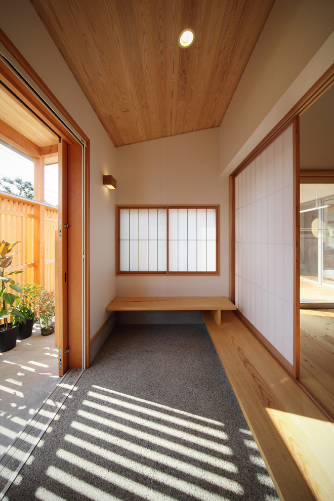 This is an example of an asian entryway in Other with a sliding front door.