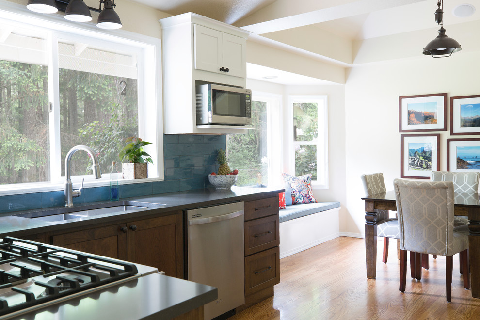 Small transitional u-shaped medium tone wood floor and brown floor kitchen pantry photo in Seattle with an undermount sink, shaker cabinets, white cabinets, quartz countertops, blue backsplash, porcelain backsplash, stainless steel appliances, no island and gray countertops