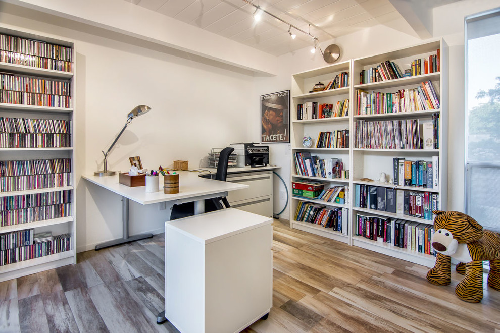 Mid-sized modern home office in San Francisco with white walls, a freestanding desk, no fireplace and brown floor.