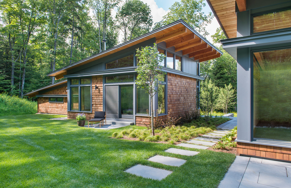 Inspiration for a small contemporary one-storey brown exterior in Burlington with wood siding and a shed roof.