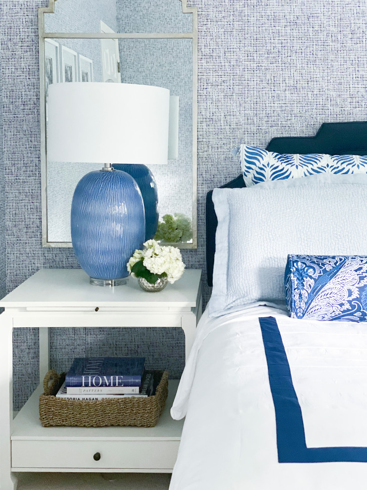 Inspiration for a small transitional guest bedroom in New York with blue walls, carpet, beige floor and wallpaper.