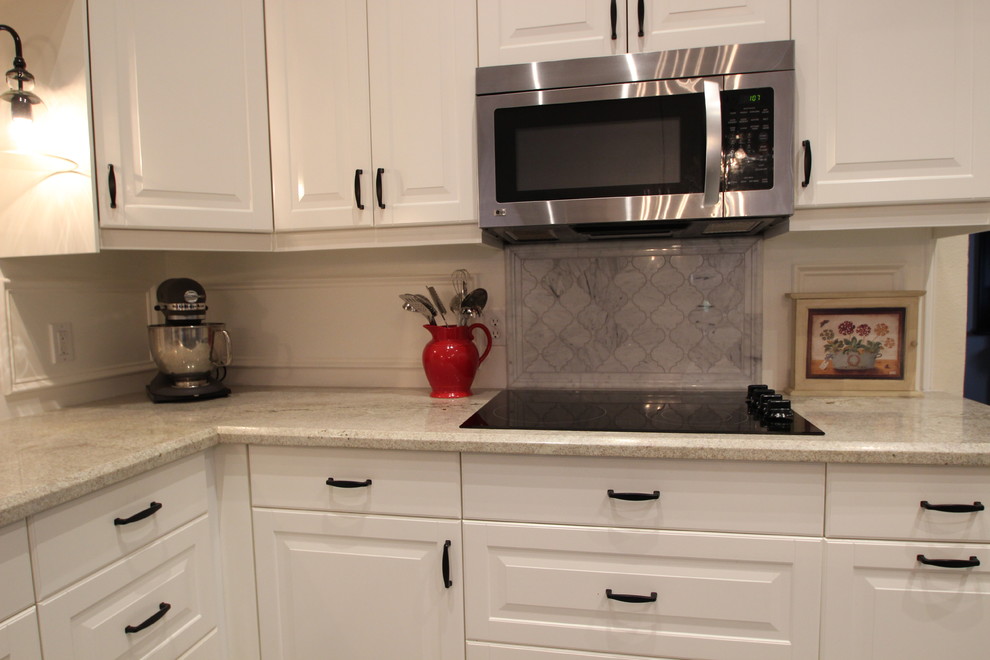 Example of a mid-sized transitional u-shaped ceramic tile enclosed kitchen design in Phoenix with a double-bowl sink, raised-panel cabinets, white cabinets, marble countertops, gray backsplash, ceramic backsplash, stainless steel appliances and an island