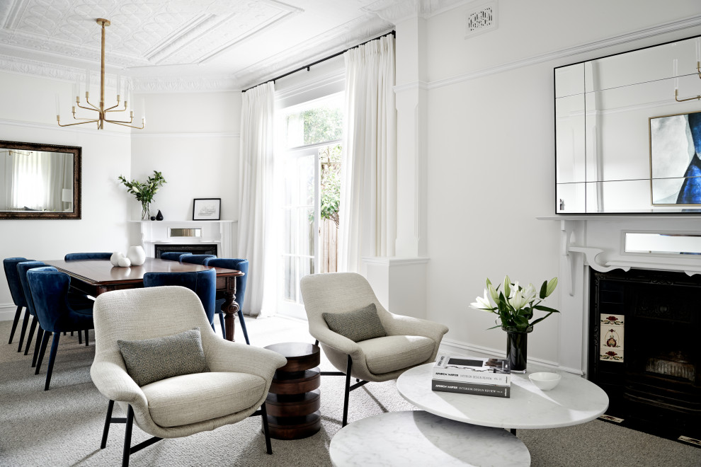This is an example of a mid-sized transitional formal open concept living room in Sydney with white walls, carpet, a corner fireplace, a metal fireplace surround, no tv and grey floor.