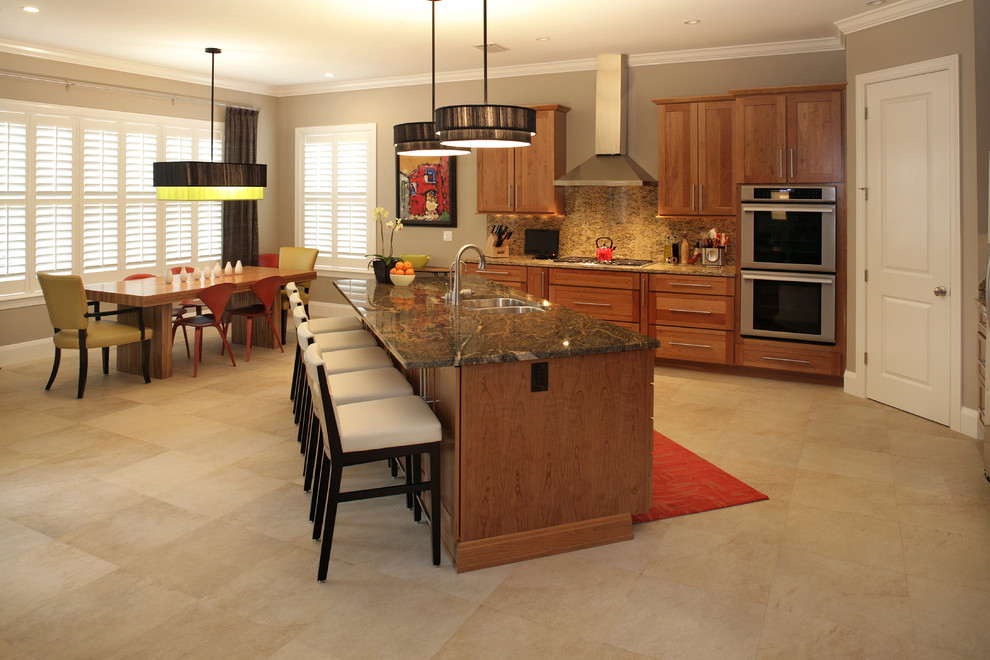 Contemporary eat-in kitchen in Tampa with stainless steel appliances and medium wood cabinets.