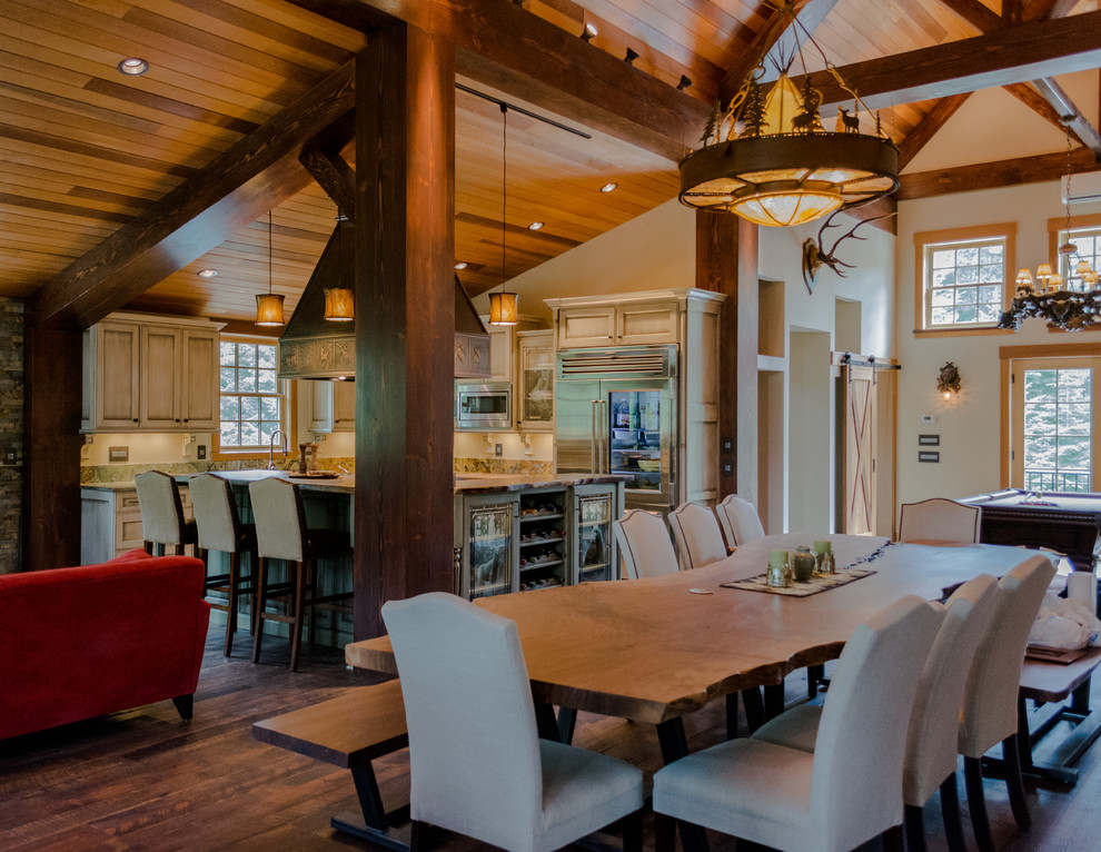 Open concept kitchen - large rustic l-shaped dark wood floor open concept kitchen idea in Portland with a farmhouse sink, recessed-panel cabinets, distressed cabinets, granite countertops, stone slab backsplash, stainless steel appliances and an island